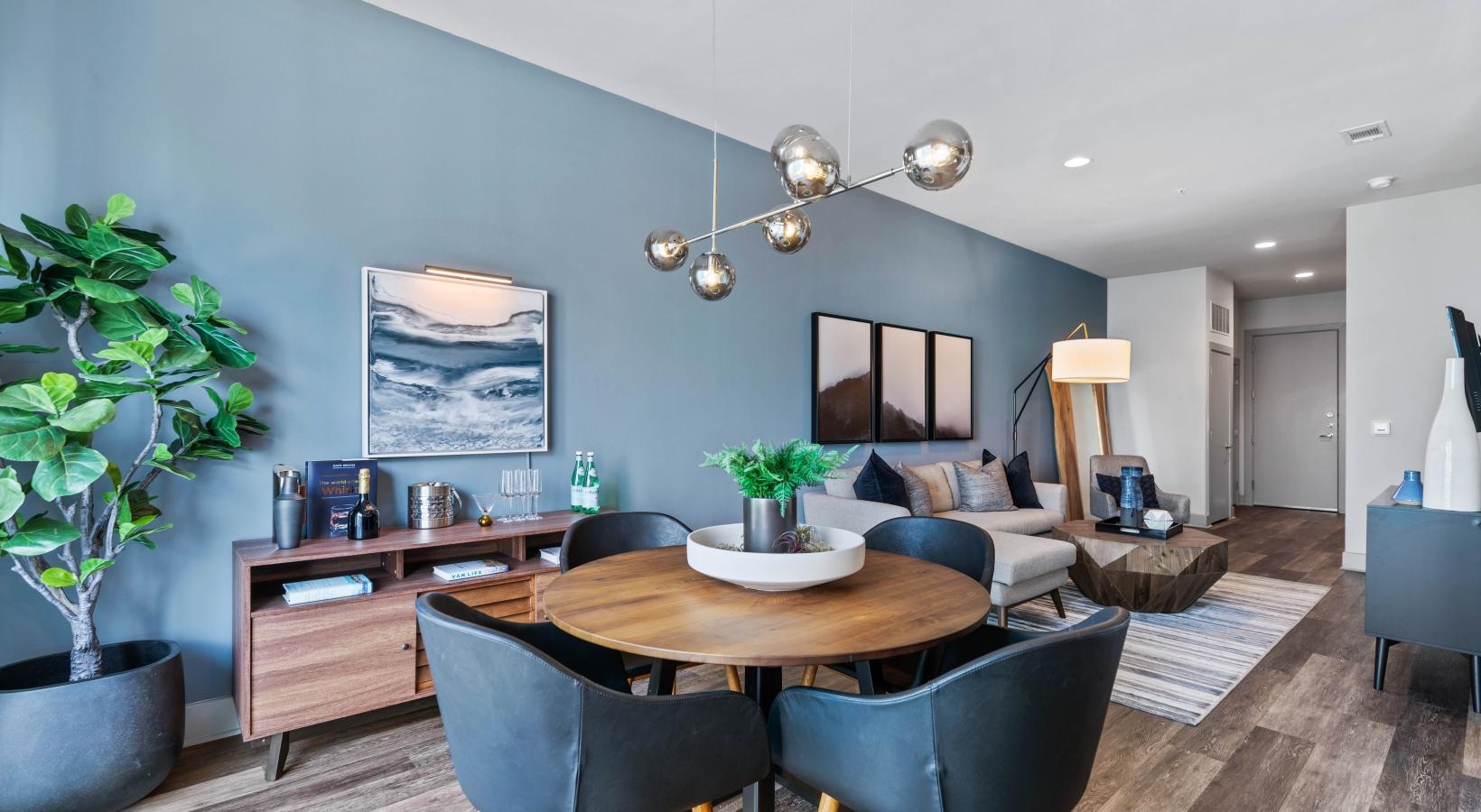 Settle into comfort at Miro a living room with a table and chairs