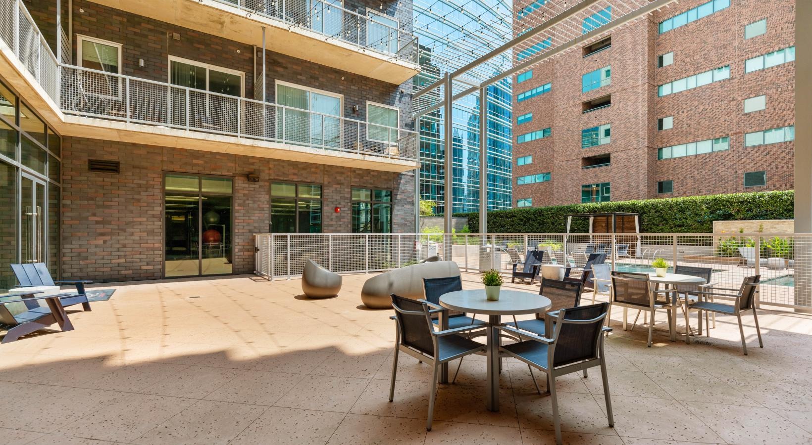 Settle into comfort at Miro a courtyard with tables and chairs