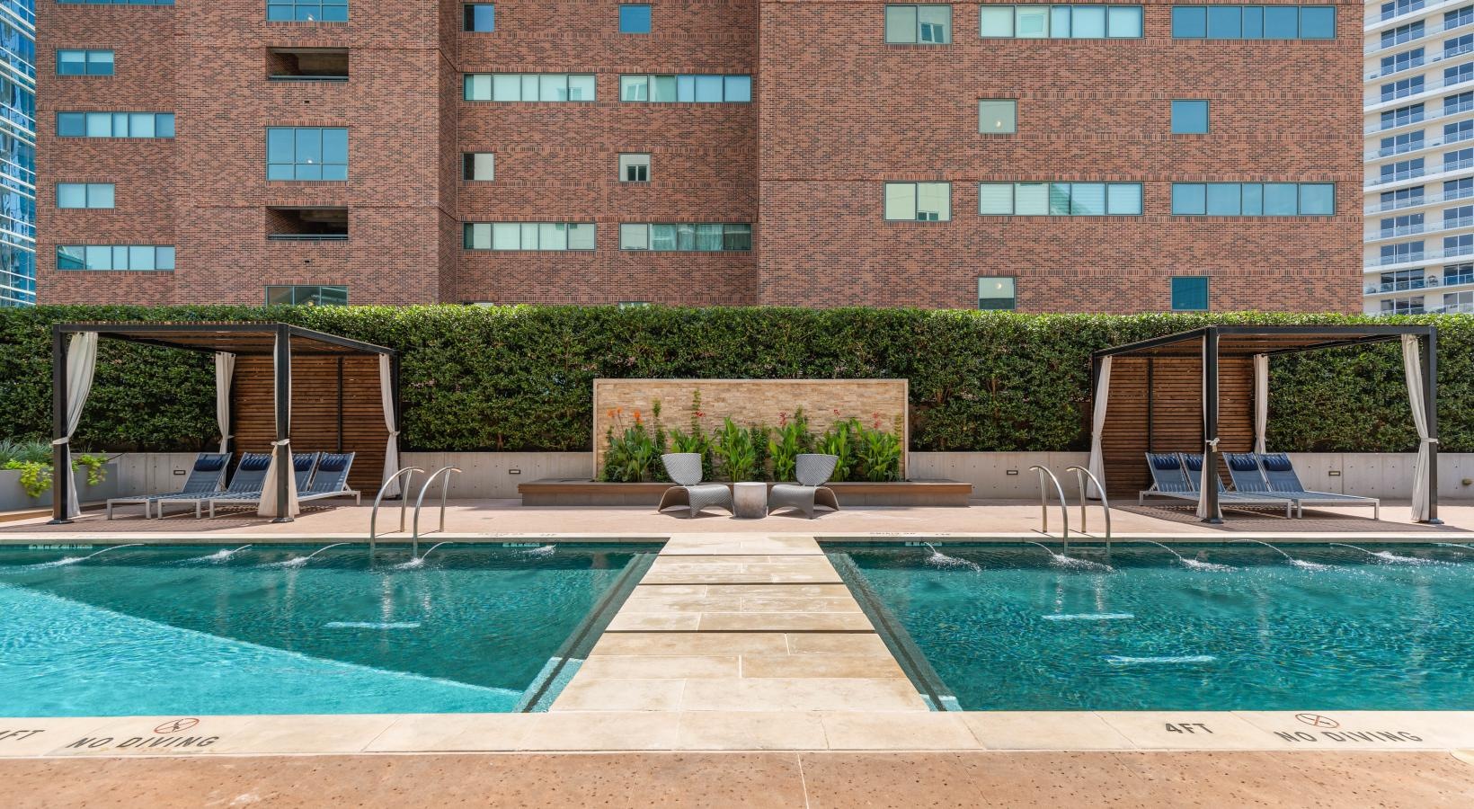 Resort-style swimming pool a pool in front of a brick building