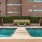 a pool in front of a brick building